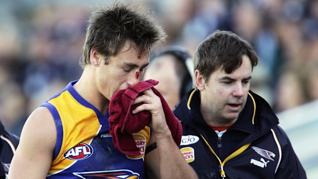 Adam Hunter of the Eagles leaves the field under the blood rule in 2006.