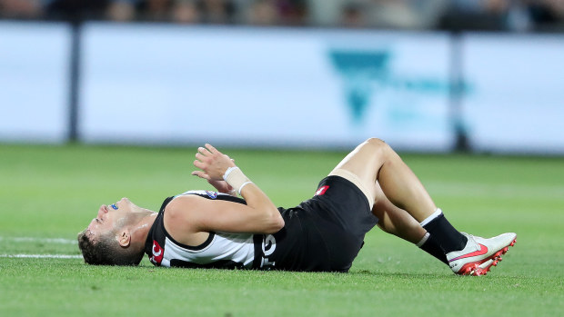 ADELAIDE, AUSTRALIA - APRIL 09: Orazio Fantasia of the Power down with an ankle injury during the 2021 AFL Round 04 match between the Port Adelaide Power and the Richmond Tigers at Adelaide Oval on April 09, 2021 in Adelaide, Australia. (Photo by Sarah Reed/AFL Photos)