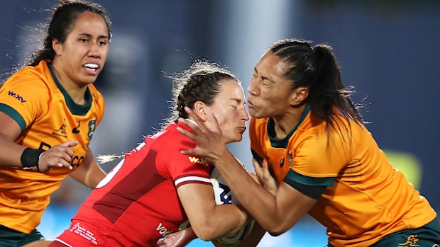 Jasmine Joyce of Wales is tackled by Siokapesi Palu of Australia.