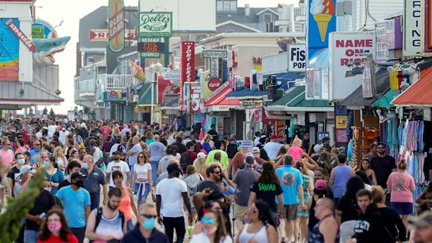 With the relaxing of coronavirus restrictions, visitors crowd the boardwalk on Memorial Day weekend in Ocean City, Maryland.