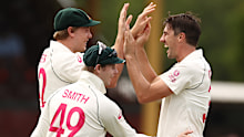 Pat Cummins and Cameron Green of Australia celebrate after taking the wicket of Shubman Gill of India.
