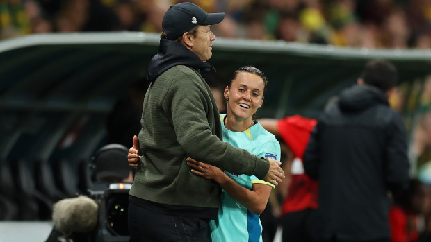 Hayley Raso is embraced by head coach Tony Gustavsson after being substituted in the second half of Australia's match against Canada.