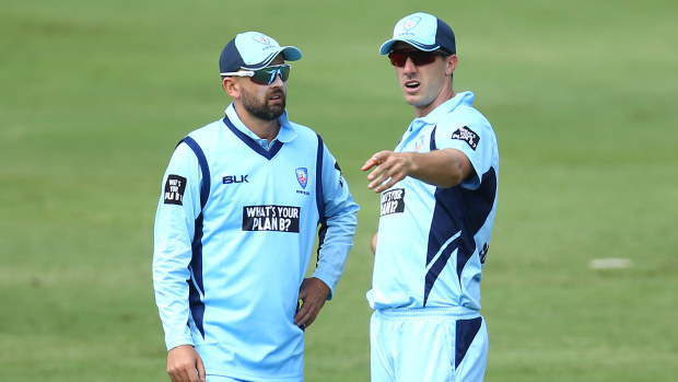 Pat Cummins talks to Nathan Lyon during the Marsh One Day Cup match between New South Wales and Victoria.