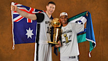 SAN ANTONIO, TX - JUNE 15: Aron Baynes and Patty Mills of the San Antonio Spurs poses for a portrait with the Larry O'Brien Trophy after defeating the Miami Heat in Game Five of the 2014 NBA Finals on June 15, 2014 at AT&T Center in San Antonio, Texas. NOTE TO USER: User expressly acknowledges and agrees that, by downloading and or using this photograph, User is consenting to the terms and conditions of the Getty Images License Agreement. Mandatory Copyright Notice: Copyright 2014 NBAE (Photo by