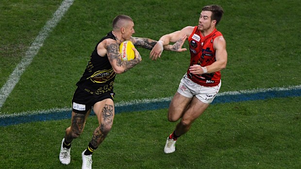 Richmond's Dustin Martin attempts to fend off Bomber Zach Merrett.