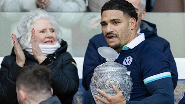 Scotland's Sione Tuipulotu with his gran Jaqueline Thomson as Phil Waugh watches on.