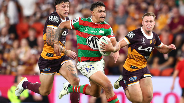 Latrell Mitchell of the Rabbitohs makes a break against the Broncos.