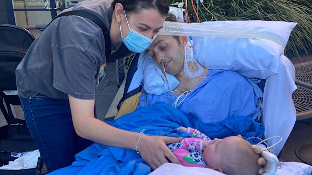 Ben pictured in Wollongong Hospital with his wife Samantha and their daughter. 