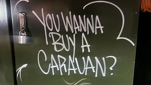 The investigation into a caravan filled with explosives is continuing today as graffiti seemingly referencing the discovery has been uncovered in Sydney's east. 