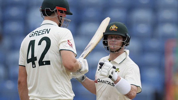 Australia's Steve Smith chats with teammate Cameron Green during their partnership against West Indies on day three of the second cricket Test match at the National Cricket Stadium in St. George's, Grenada, Saturday, July 5, 2025. (AP Photo/Ricardo Mazalan)