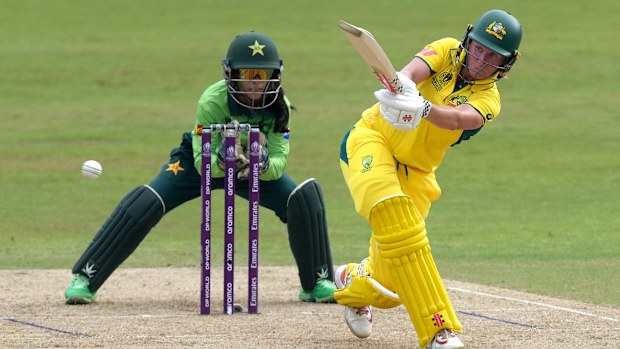 Australia's Beth Mooney plays a shot as Pakistan wicketkeeper Sidra Nawaz waits behind the stumps at the Women's Cricket World Cup.
