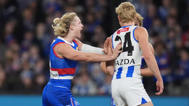 Cody Weightman shoves Jackson Archer after kicking a goal during the round 16 AFL match between the North Melbourne Kangaroos and the Western Bulldogs.