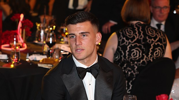 Nick Daicos of the Magpies look on.