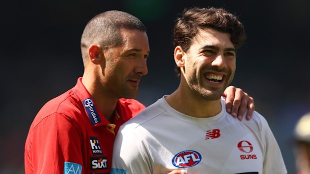 Suns assistant coach Shaun Grigg chats with Christian Petracca at training.