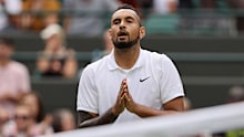 Nick Kyrgios interacts with the crowd after retiring from WImbledon due to injury in 2021.