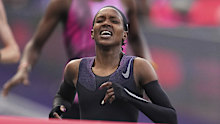Faith Kipyegon, from Kenya, approaches the finish line in her attempt to become the first woman to run a mile in under four minutes.