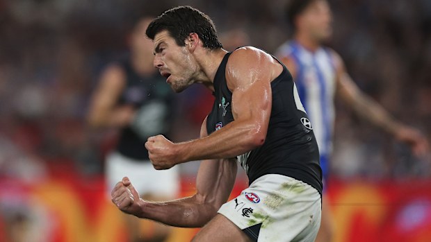 George Hewett of the Blues celebrates kicking a goal.
