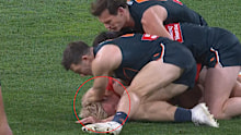 Toby Greene whacks Isaac Heeney on the ground.