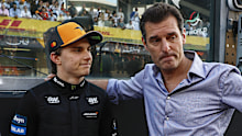 ABU DHABI, UNITED ARAB EMIRATES - DECEMBER 07: Oscar Piastri of Australia and McLaren and Mark Webber on the grid during the F1 Grand Prix of Abu Dhabi at Yas Marina Circuit on December 07, 2025 in Abu Dhabi, United Arab Emirates. (Photo by Andrew Ferraro/LAT Images)