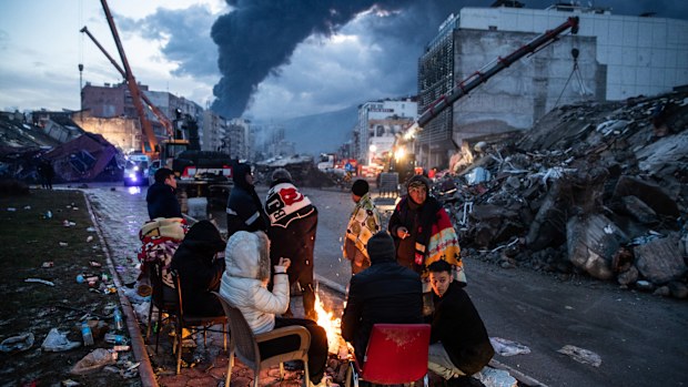 People try to rescue their loved ones, believed to be trapped under collapsed building in Iskenderun, Turkey. 