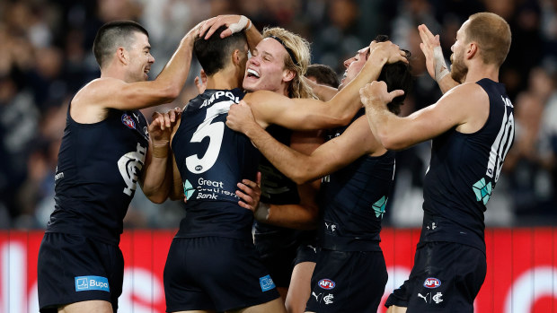 Tom De Koning of the Blues (centre) celebrates with teammates during the 2024 AFL Round 01 match between the Carlton Blues and the Richmond Tigers at the Melbourne Cricket Ground on March 14, 2024 in Melbourne, Australia. (Photo by Michael Willson/AFL Photos via Getty Images)