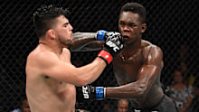 Kelvin Gastelum (left) and Israel Adesanya exchange strikes in UFC 236.