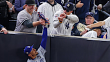 NEW YORK, NEW YORK - OCTOBER 29:  Fans interfere with Mookie Betts #50 of the Los Angeles Dodgers as he attempts to catch a fly ball in foul territory during the first inning of Game Four of the 2024 World Series against the New York Yankees at Yankee Stadium on October 29, 2024 in the Bronx borough of New York City. The play resulted in an out. (Photo by Al Bello/Getty Images)