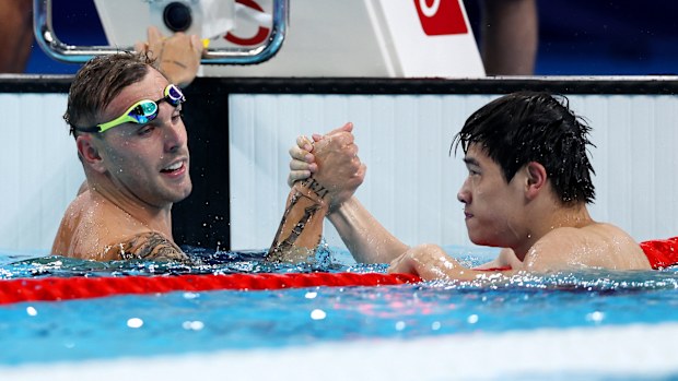 Zhanle Pan of Team People's Republic of China celebrates with Kyle Chalmers of Team Australia after winning gold and silver in the Men's 100m Freestyle Final on day five of the Olympic Games Paris 2024 at Paris La Defense Arena on July 31, 2024 in Nanterre, France. (Photo by Quinn Rooney/Getty Images)