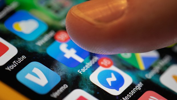 FILE - This Aug. 11, 2019, file photo an iPhone displays the apps for Facebook and Messenger in New Orleans. From complaints whistleblower Frances Haugen has filed with the SEC, along with redacted internal documents obtained by The Associated Press, the picture of the mighty Facebook that emerges is of a troubled, internally conflicted company, where data on the harms it causes is abundant, but solutions are halting at best. (AP Photo/Jenny Kane, File)