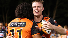 SYDNEY, AUSTRALIA - MARCH 23: Lachlan Galvin of the Tigers embraces with his teammate after winning the round three NRL match between Wests Tigers and Cronulla Sharks at Leichhardt Oval, on March 23, 2024, in Sydney, Australia. (Photo by Jeremy Ng/Getty Images)