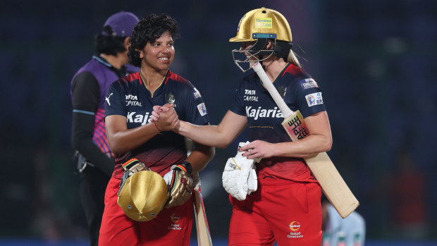 Richa Ghosh of Royal Challengers Bangalore and Ellyse Perry of Royal Challengers Bangalore celebrate their team's win over  Mumbai Indians during the WIPL match between Mumbai Indians and Royal Challengers at Arun Jaitley Stadium on March 12, 2024 in Delhi, India. (Photo by Pankaj Nangia/Getty Images)