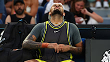 Nick Kyrgios reacts to an abdominal injury during his first-round match against Jacob Fearnley at the Australian Open.