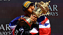 Race winner Lewis Hamilton of Great Britain and Mercedes celebrates on the podium during the F1 Grand Prix of Great Britain at Silverstone Circuit.