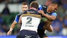 Kurtley Beale of the Force attempts to break the tackle from Billy Pollard of the Brumbies.