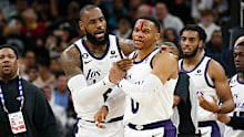 LeBron James checks on Russell Westbrook after he received a hit on a drive to the basket by Zach Collins.