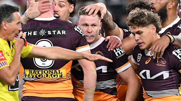 Billy Walters celebrates with Broncos teammates.