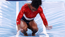 Simone Biles of Team United States stumbles upon landing after competing in vault during the Women's Team Final on day four of the Tokyo 2020 Olympic Games.