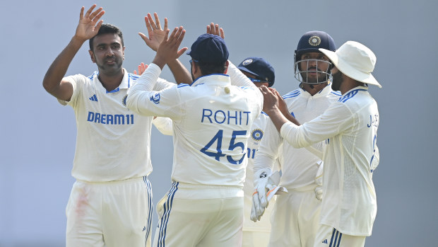 India bowler Ravi Ashwin is congratulated by captain Rohit Sharma after taking the wicket of Zak Crawley to reach his 500th Test Wicket during day two of the 3rd Test Match between India and England at Saurashtra Cricket Association Stadium on February 16, 2024 in Rajkot, India. (Photo by Gareth Copley/Getty Images)