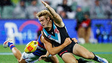 Power young gun Jason Horne-Francis is tackled by Western Bulldogs player Liam Jones.