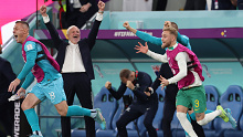 Danny Vukovic, Nathaniel Atkinson and Andrew Redmayne celebrate along with Graham Arnold as the full-time whistle blows on the Socceroos' win over Denmark.