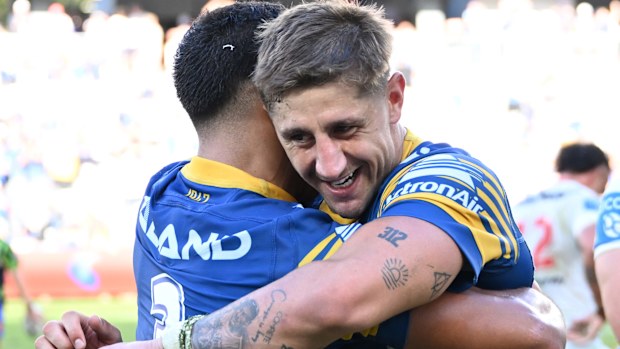 Zac Lomax and Will Penisini embrace.