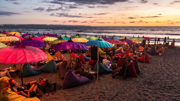 Kuta beach in Seminyak, Bali is popular at sunset, but the island is being hit by volcano-related cancellations.