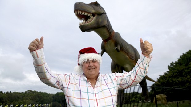 BRISBANE. NEWS. SUN-HERALD. Photograph taken by Michelle Smith on Saturday 22nd December, 2012. Clive Palmer gets into the Christmas spirit with Jeff the dinosaur at the Palmer Coolum Resort where he will host a lunch for 700 people in need on Christmas Day this year.