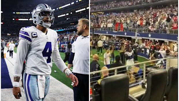 Cowboys quarterback Dak Prescott leaves the field, as fans can be seen hurling rubbish onto the field.