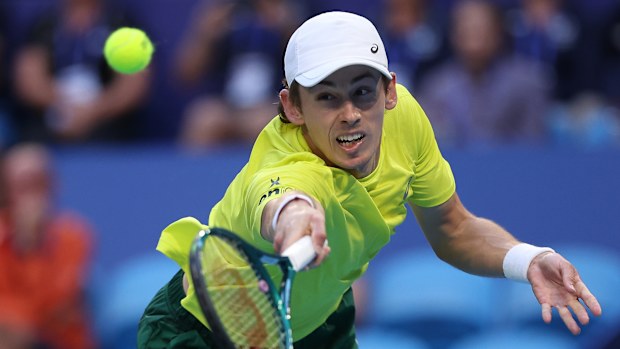 PERTH, AUSTRALIA - JANUARY 03: Alex de Minaur of Team Australia stretches to play a backhand in his singles match against Novak Djokovic of Team Serbia during day six of the 2024 United Cup at RAC Arena on January 03, 2024 in Perth, Australia. (Photo by Paul Kane/Getty Images)