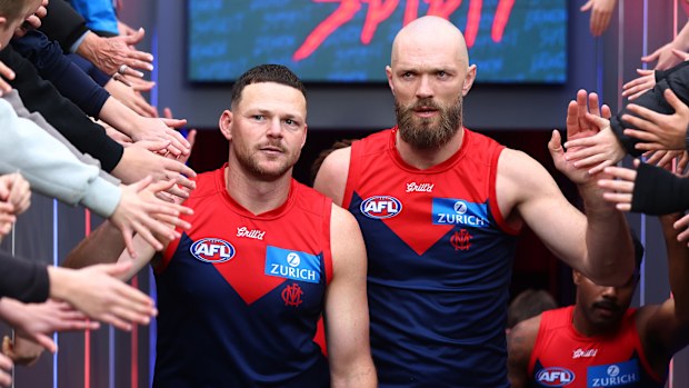 Steven May and Max Gawn lead the Demons players out.