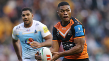 SYDNEY, AUSTRALIA - JUNE 15: Stefano Utoikamanu of the Wests Tigers runs the ball during the round 15 NRL match between Wests Tigers and Gold Coast Titans at Leichhardt Oval on June 15, 2024 in Sydney, Australia. (Photo by Jason McCawley/Getty Images)