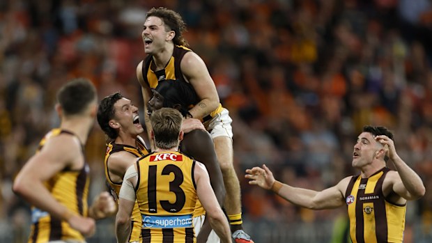 Mabior Chol of the Hawks is congratulated by teammates after kicking a goal.