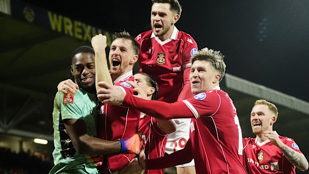 Wrexham goalkeeper Arthur Okonkwo (left) celebrates with Dominic Hyam and team-mates after saving the deciding penalty in the shoot-out from Nottingham Forest's Omari Hutchinson during the Emirates FA Cup third round match at SToK Racecourse, Wrexham. Picture date: Friday January 9, 2026. (Photo by Nick Potts/PA Images via Getty Images)
