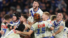 Matt Burton of the Bulldogs celebrates with team mates after kicking the match winning field goal.